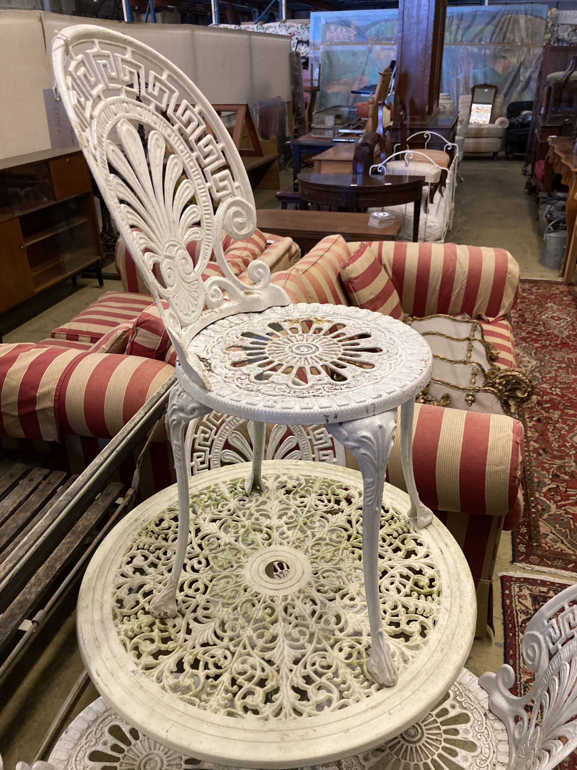 A circular Victorian style painted aluminium garden table, diameter 69cm together with a set of four similar chairs